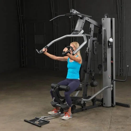 Body-Solid Single Stack Gym G5S - Woman sitting on G1S doing arm workout