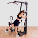 Body-Solid Single Stack Home Gym G1S - Woman standing beside G1S with weights attached to her foot