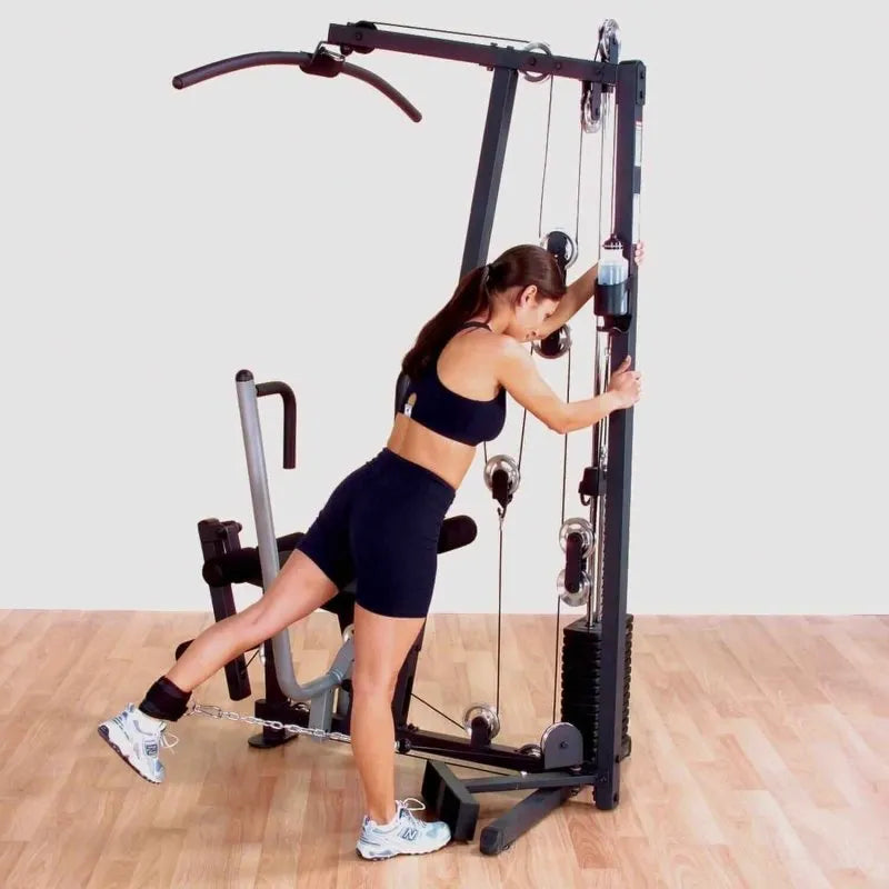 Body-Solid Single Stack Home Gym G1S - Woman standing beside G1S with weights attached to her foot