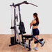 Body-Solid Single Stack Home Gym G1S - Female model standing while pulling weights with her foot