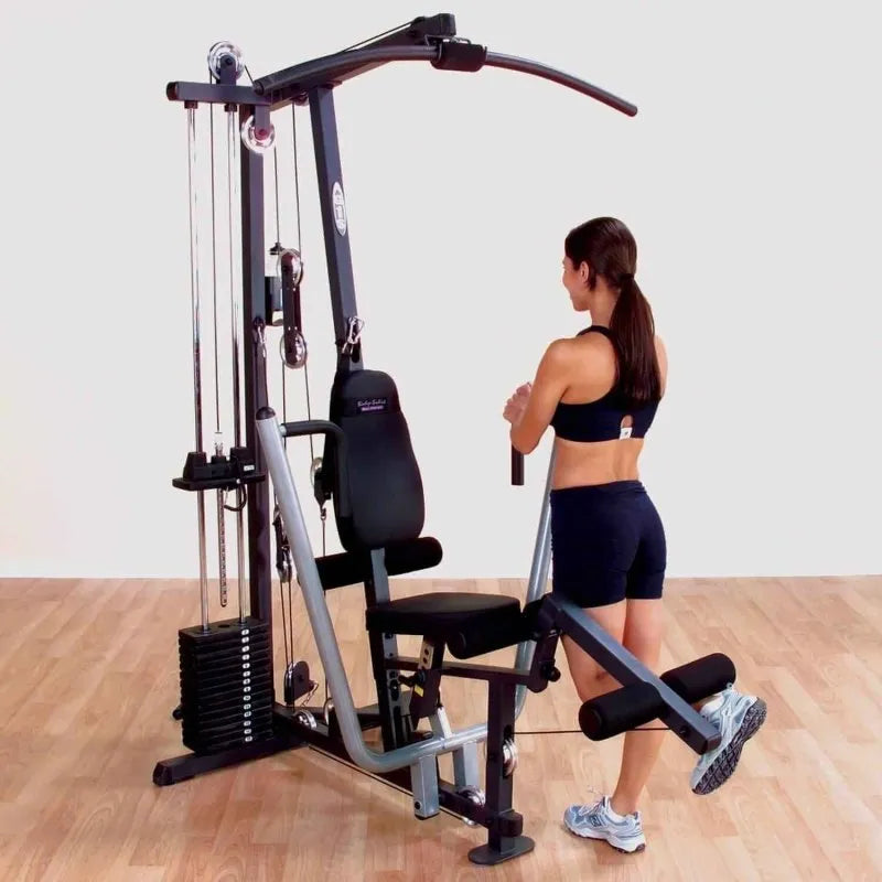 Body-Solid Single Stack Home Gym G1S - Female model standing while pulling weights with her foot
