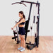 Body-Solid Single Stack Home Gym G1S - Woman pulling weights with her left arm while standing up