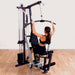 Body-Solid Single Stack Home Gym G1S - Woman sitting on bench pulling weights