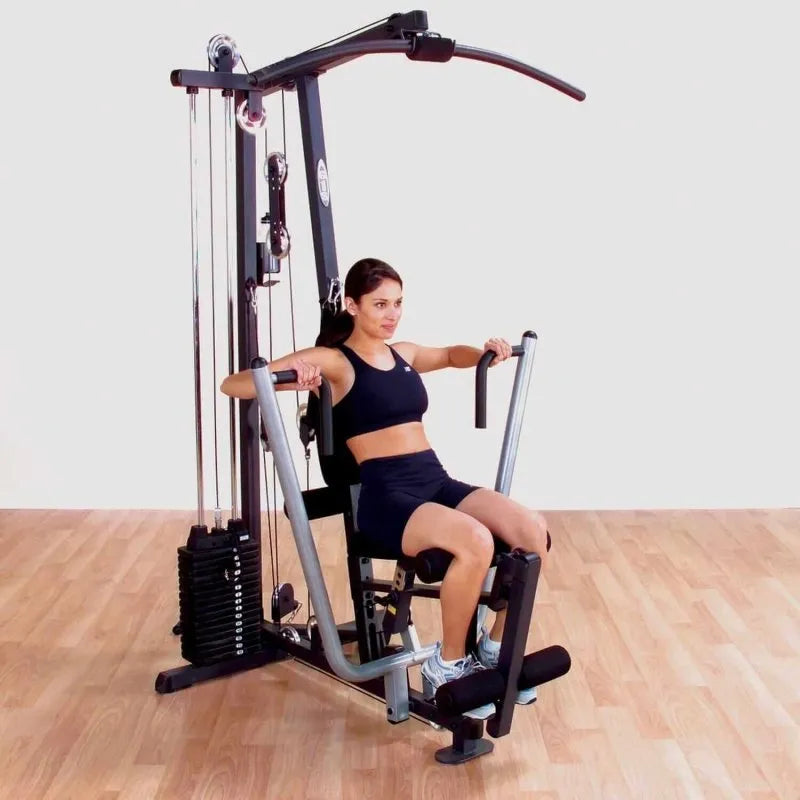 Body-Solid Single Stack Home Gym G1S - Woman sitting on bench doing lateral arm exercise