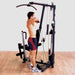Body-Solid Single Stack Home Gym G1S - Man pulling weights with hands while standing up