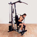 Body-Solid Single Stack Home Gym G1S - Woman sitting on bench pulling weights from her back
