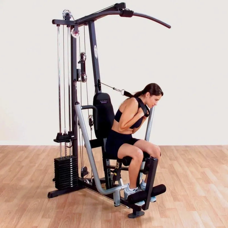 Body-Solid Single Stack Home Gym G1S - Woman sitting on bench pulling weights from her back