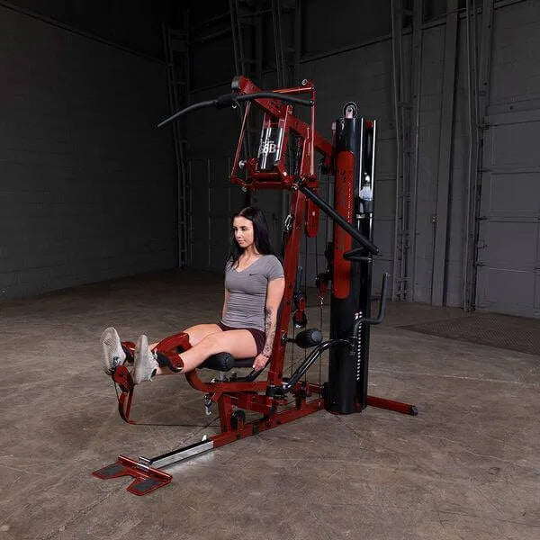 Body-Solid Single Stack Home Gym G6BR - Woman sitting on bench lifting her legs doing workout