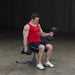 Body-Solid Utility Stool GST20 - Man in red top sitting on stool holding 2 dumbbells