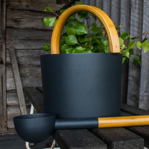 KOLO Sauna Set 2 - Black beside a plant