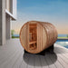 Golden Designs "Arosa" 4 Person Barrel Traditional Steam Sauna - Pacific Cedar - a wooden barrel on a deck with a pool in the background