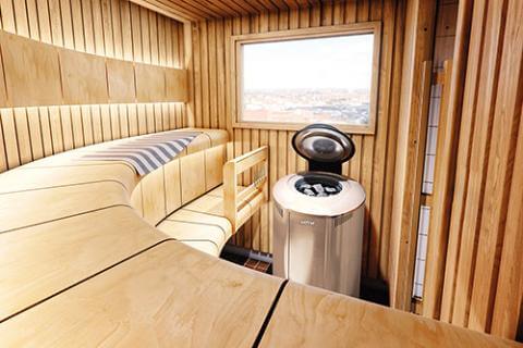 Harvia Forte Series Sauna Heater with Digital Controls - inside a cozy cabin-like sauna room