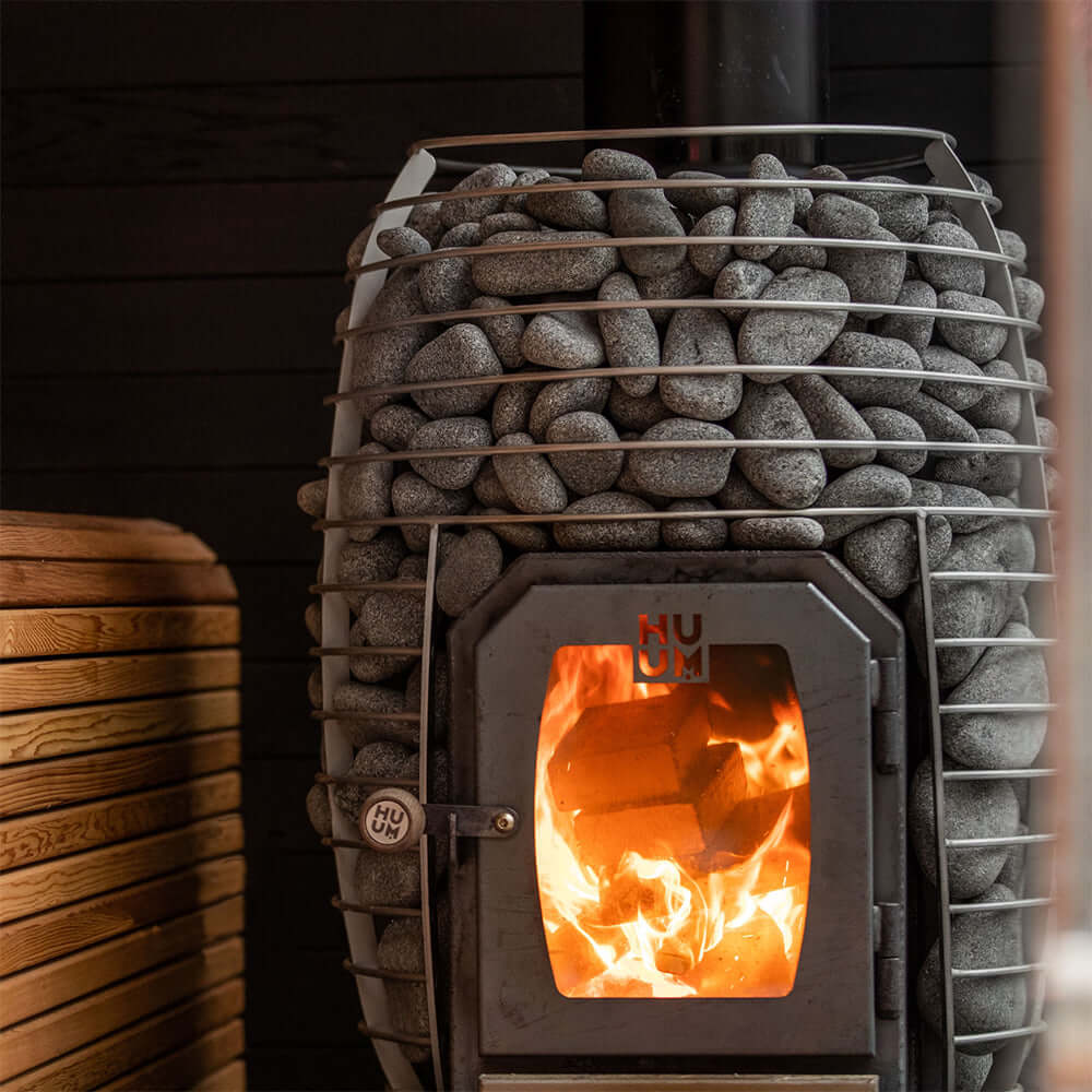 HUUM HIVE Wood Series 17kW LS Sauna Heater Package - Close up view of metal basket with sauna stones and heater