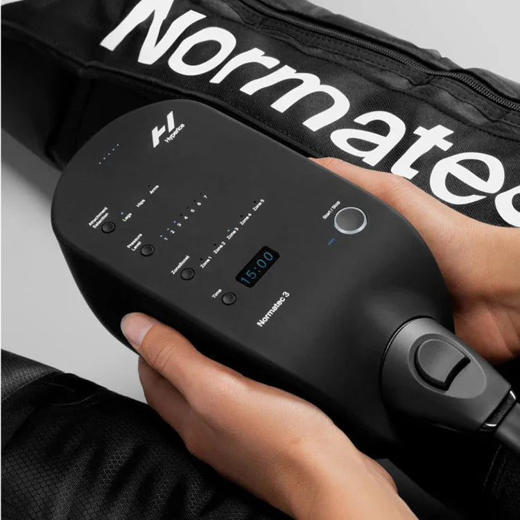 Hyperice Normatec 3 Leg Recovery System - Two hands holding the controls for the device