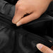 Hyperice Normatec 3 Leg Recovery System -  Close up image of a person's hand opening a zipper