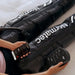 Hyperice Normatec 3 Leg Recovery System -  a person lying on a bed while wearing leg system and holding a phone
