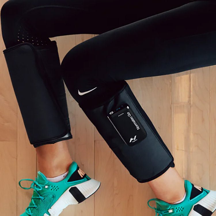 Hyperice Normatec Go - Worn by a lady with green shoes