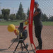 Powernet Launch F-lite Baseball and Softball Pitching Machine 1194 - a player using the machine 