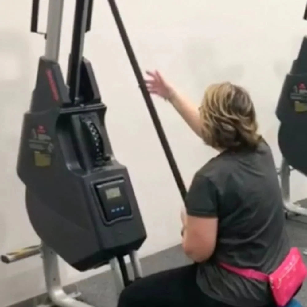 Marpo VMX Rope Trainer Multi-Mode - back view of a woman sitting on machine while pulling rope