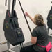 Marpo VMX Rope Trainer Multi-Mode - back view of a woman sitting on machine while pulling rope