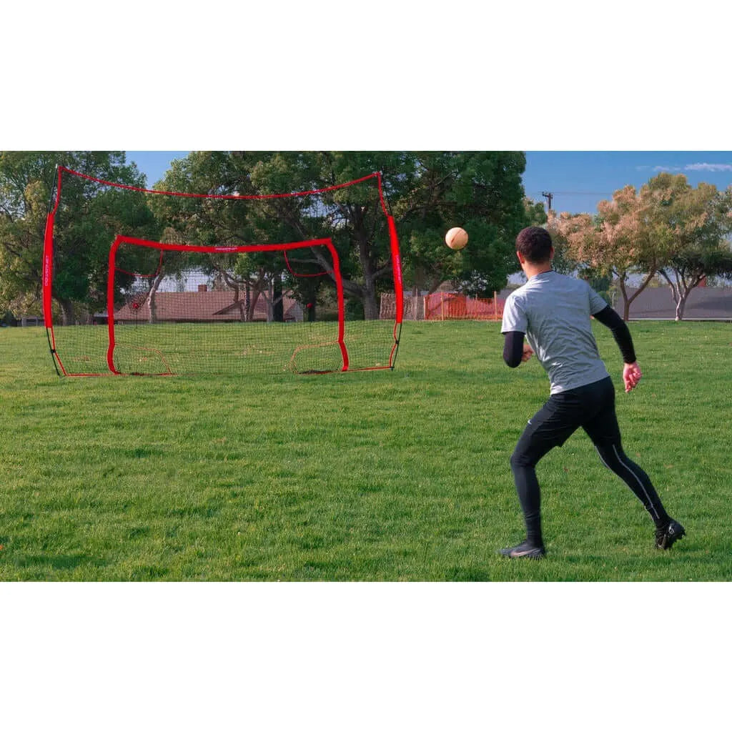 A boy playing outdoor soccer using Powernet 16x10 Ft Soccer Goal Combo Barrier 1214