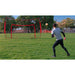 A boy playing outdoor soccer using Powernet 16x10 Ft Soccer Goal Combo Barrier 1214
