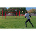 A boy playing outdoor soccer using Powernet 16x10 Ft Soccer Goal Combo Barrier 1214