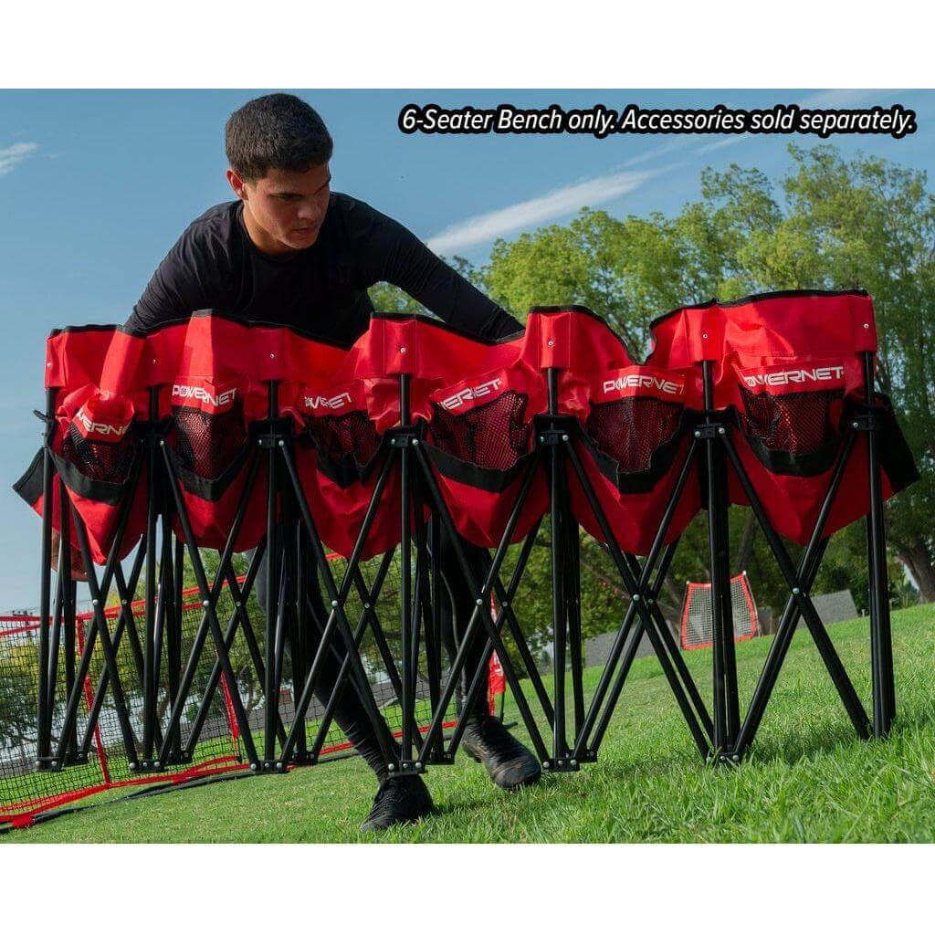 A boy setting up a Powernet 6-Seater Team Bench 1209 in a field