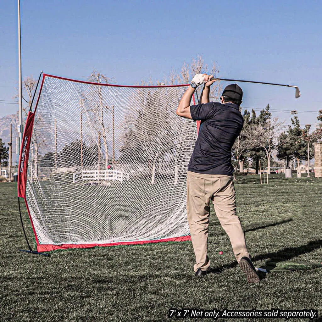 Powernet 7x7 FT Golf Hitting Net 1031 - A man energetically swings his golf club in an open field