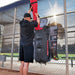 A person putting equipment in Powernet All Gear Transporter Rolling Baseball Equipment Bag for Coaches B007