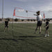 Powernet Freestanding Volleyball Warm Up Net 1178 - with woman doing a volleball spike 