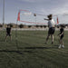 Powernet Freestanding Volleyball Warm Up Net 1178 - with woman doing a volleball spike 