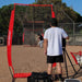 Powernet I-Screen Net for Batting Practice - A man stands confidently in front of a baseball batting cage