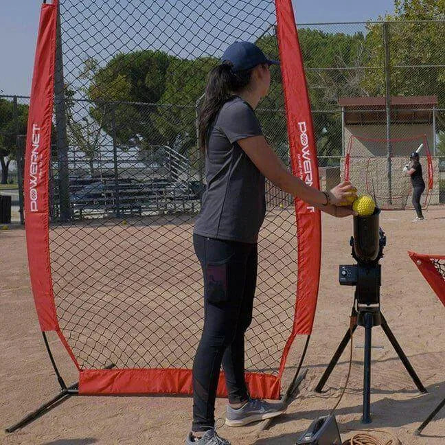 Powernet I-Screen Net for Batting Practice - A woman stands poised with a baseball bat and a softball