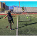 Powernet Rebounder Training Net 1125 - A player kicks a soccer ball toward a rebound net on a sunny field