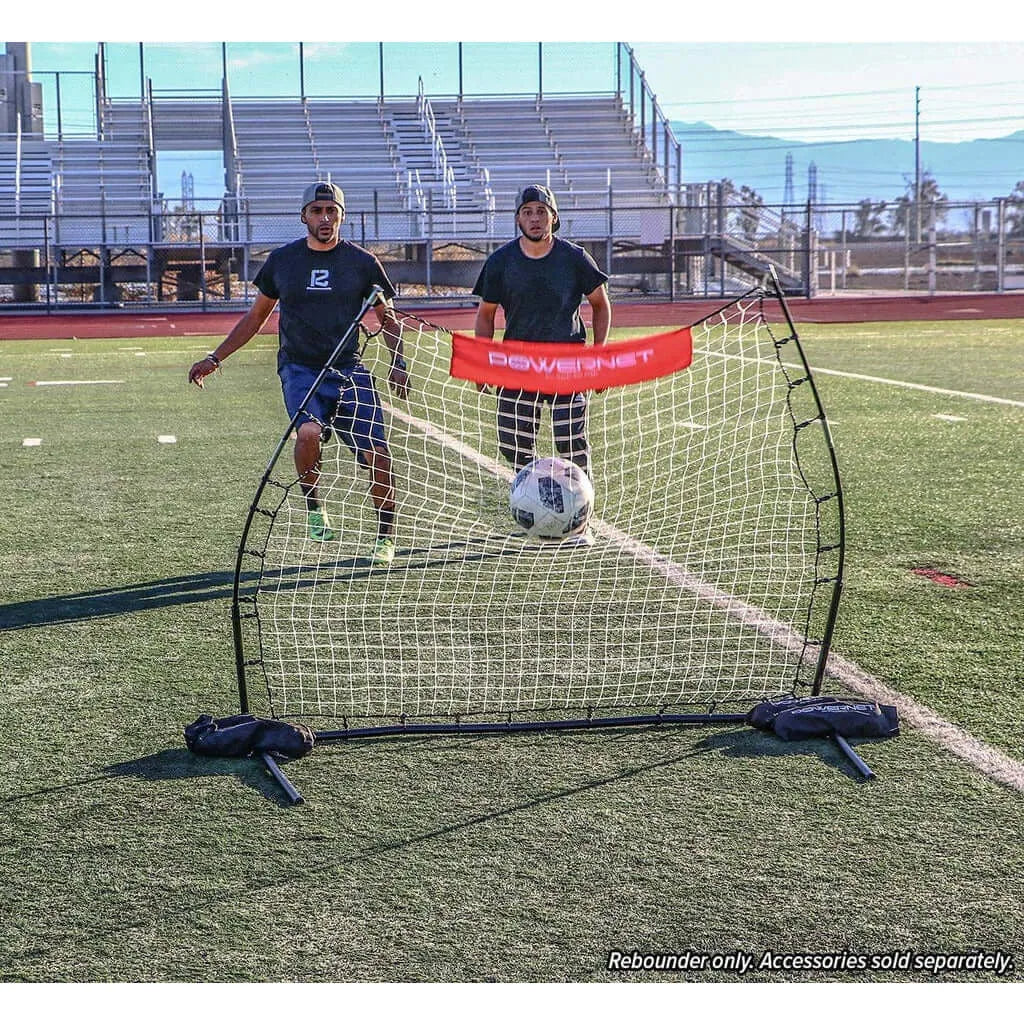 Powernet Training Net 6' x 4' Fast Pass Rebounder Trainer Soccer Bundle - 2 men playing soccer in an open field on a sunny day