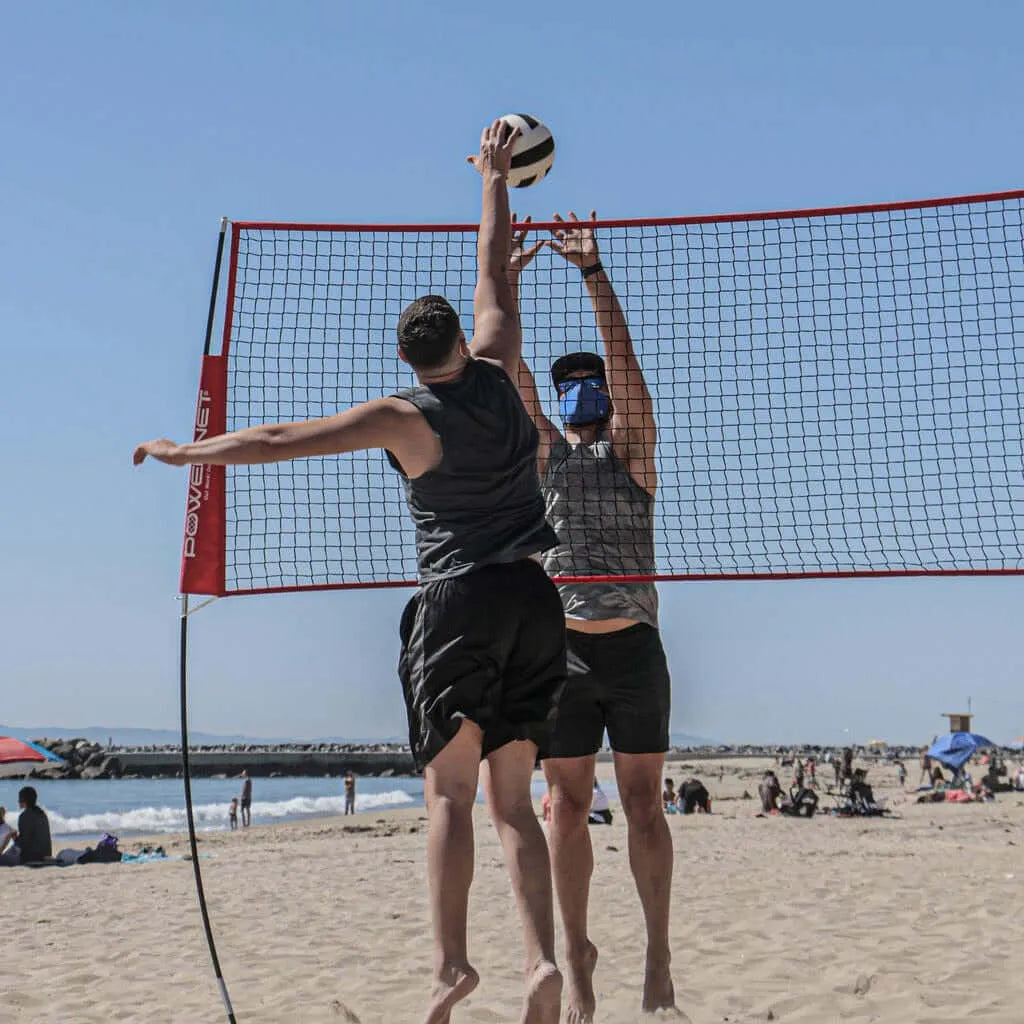 Powernet Volleyball Four Square Net used by two people playing beach volleyball