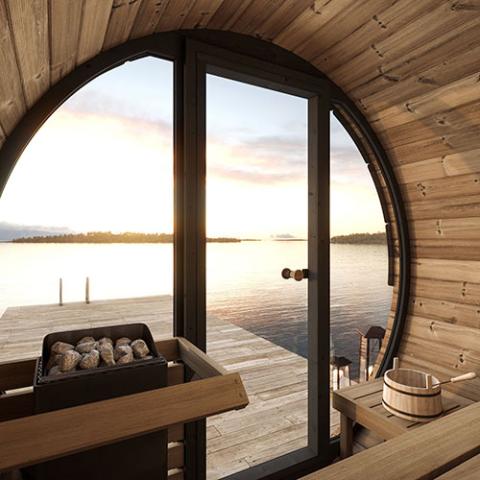 SaunaLife Model EE6G Sauna Barrel - a wooden sauna with a door open to the water