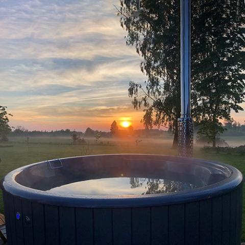 SaunaLife Model S4N Wood-Fired Hot Tub - hot tub assembled outside with view of sunset