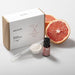 Saunum Grapefruit Aroma Oil with Reservoir, 10ml - with grapefruit and dropper beside a box