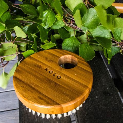 Kolo Bath Brush Bambu - Brush outdoor beside a green plant