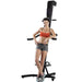 VersaClimber TS Magnetic Commercial Vertical Climber - a woman posing for a picture in front of exercise machine