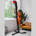 VersaClimber TS Magnetic Commercial Vertical Climber - a woman in orange workout clothes climbing on VersaClimber set up in a room with a big window