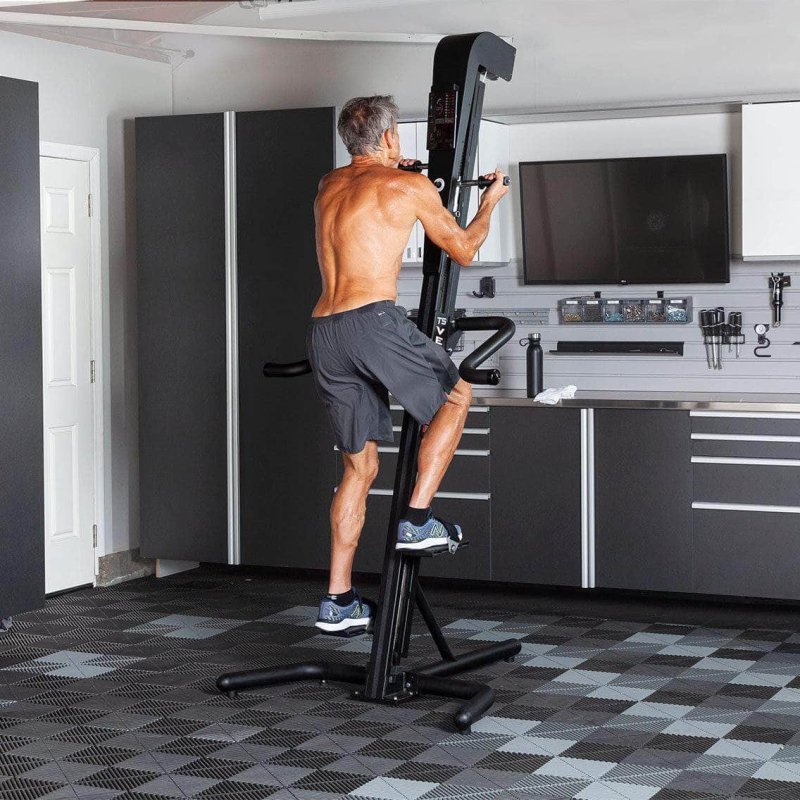 VersaClimber TSA Commercial Vertical Climber - a man on a machine assembled in a gray kitchen