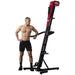 VersaClimber TSA Commercial Vertical Climber - a man standing next to black and red exercise machine