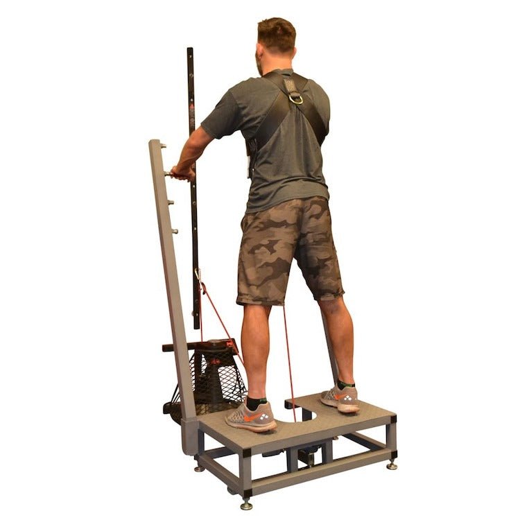 VersaClimber VersaPulley Squat Deck - a man standing on a machine