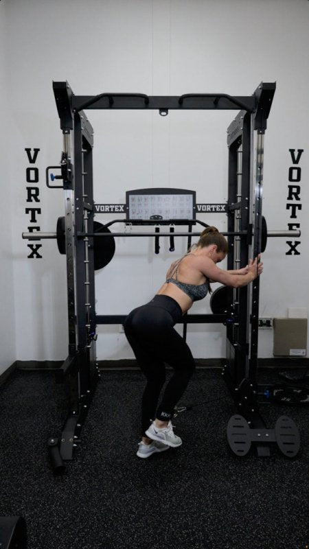 Vortex Strength VX1000 Smith Machine and Functional Trainer -  woman working out holding the side of the machine