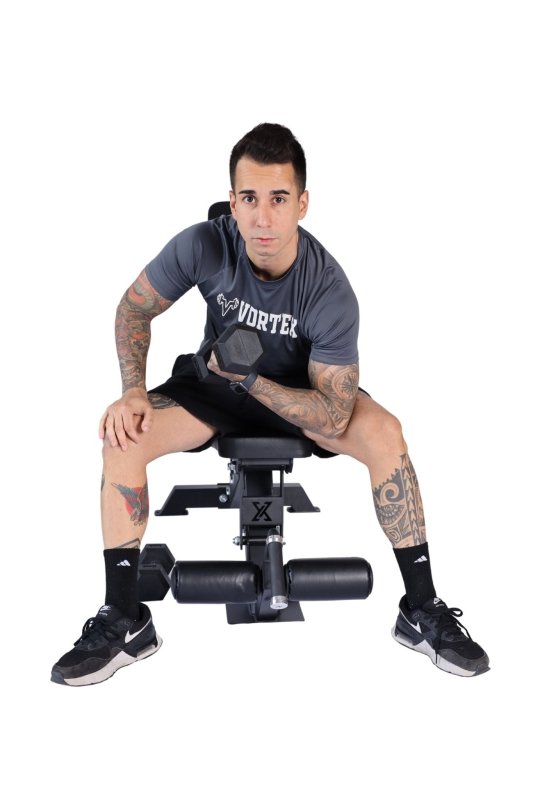 Vortex Strength VXFIDL250 Commercial FID Adjustable Bench with Leg Holders - Man sitting on bench posing with a dumbbell on his right arm 