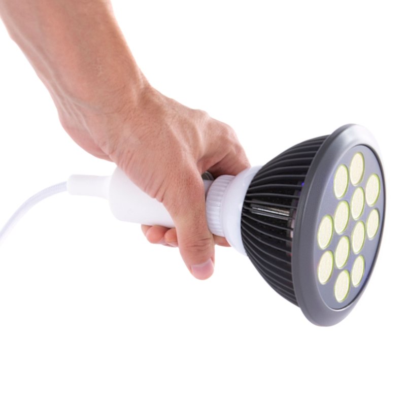 Yellow LED Light Therapy - hand holding a bulb