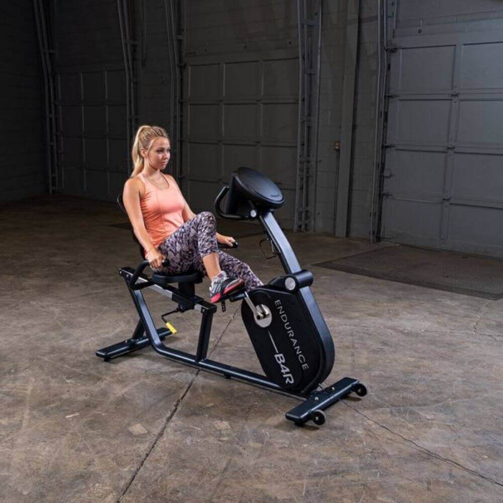 Body-Solid Endurance Recumbent Bike B4RB - front view of the product with woman using the bike